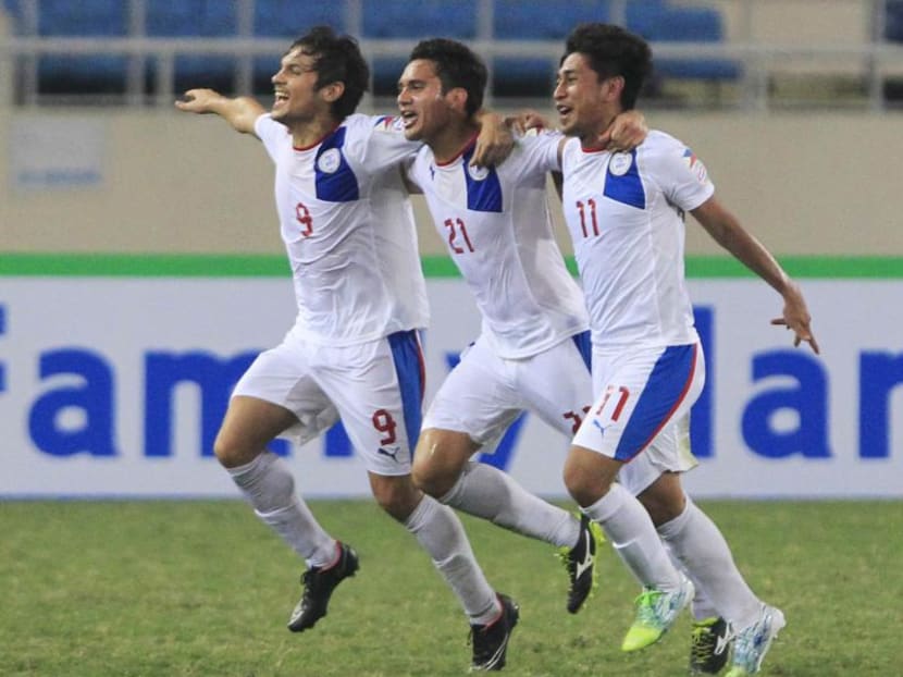 Martin Steuble (C) of the Philippines celebrate with teammates Misagh Bahadoran (L) and Daisuke Sato after scoring against Indonesia during their Suzuki Cup Group A match at My Dinh Stadium in Hanoi in 2014. The Philippines will be co-hosting the 2016 edition of the football tournament with Myanmar. Photo: Reuters