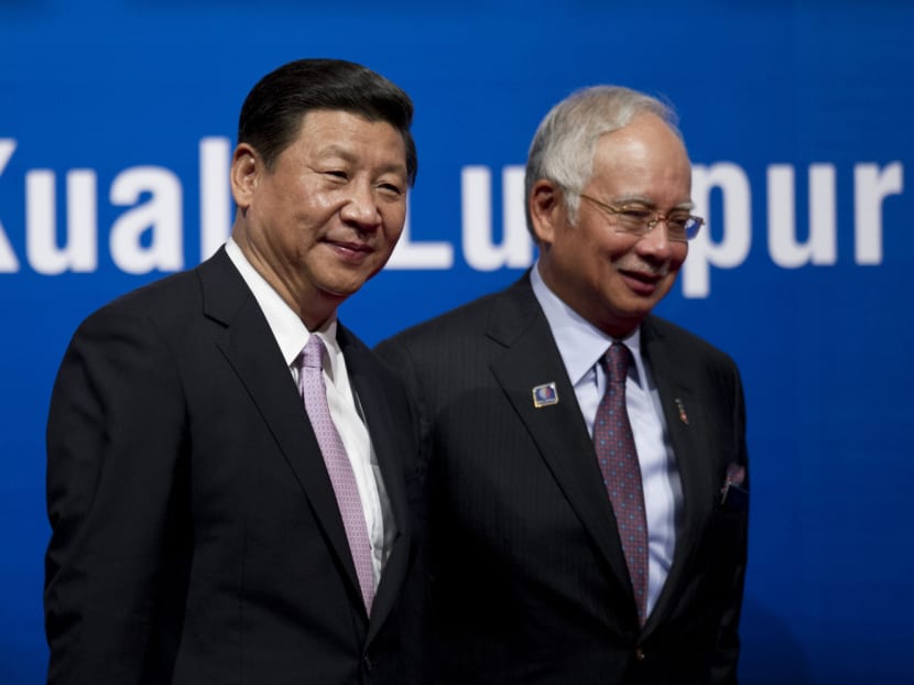 China's President Xi Jinping (left) and Malaysian Prime Minister Najib Razak (right) walk after the Malaysia-China Economic Summit in Kuala Lumpur on Oct 4, 2013. Photo: AFP