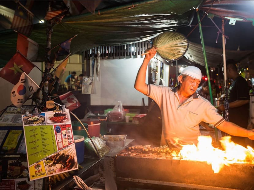 With automation in food courts going the way it is, could a human vendor, like this satay seller at Lau Pa Sat, be a thing of the past? Photo: Bloomberg