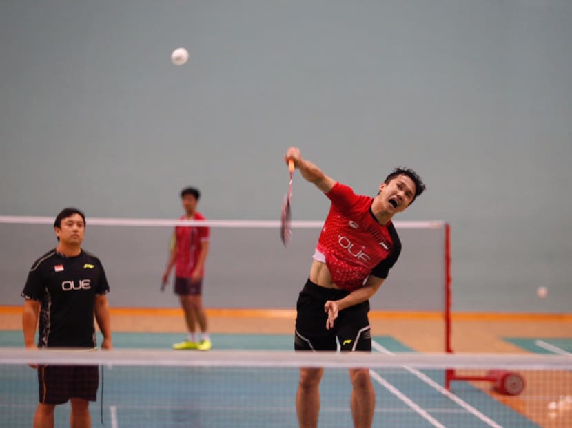 Singapore's top men's shuttler Ryan Ng at training while his coach Ding Chao watches on. Photo: Najeer Yusof