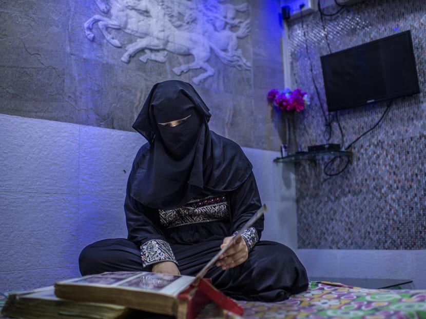 Neeha Khan, whose husband divorced her with a letter that repeated the word “talaq” three times, looking at her wedding album at her home in suburban Mumbai, India, May 17, 2017. The Supreme Court of India is poised to rule on complaints filed by five Muslim women who argue that being divorced in this way violates their fundamental right to equality under the Indian Constitution. Photo: New York Times