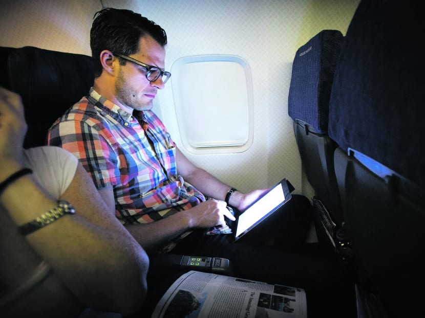 A passenger uses a wireless tablet on an American Airlines airplane. Photo: Reuters