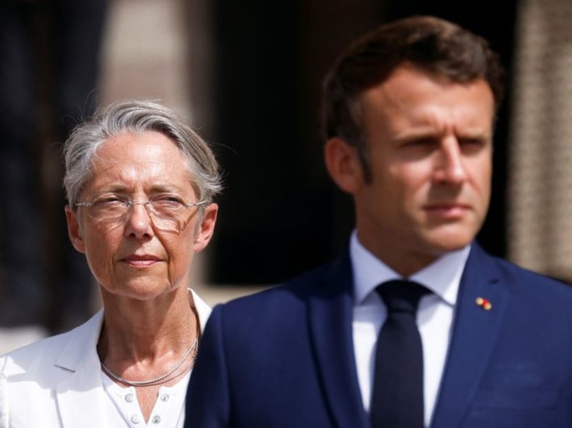 FILE PHOTO: French President Emmanuel Macron and French Prime Minister Elisabeth Borne attend a ceremony marking the 82nd anniversary of late French General Charles de Gaulle's resistance call of June 18, 1940, at the Mont Valerien memorial in Suresnes near Paris, France, June 18, 2022. REUTERS/Gonzalo Fuentes/Pool FILE PHOTO: French President Emmanuel Macron and French Prime Minister Elisabeth Borne attend a ceremony marking the 82nd anniversary of late French General Charles de Gaulle's resistance call of June 18, 1940, at the Mont Valerien memorial in Suresnes near Paris, France, June 18, 2022. REUTERS/Gonzalo Fuentes/Pool