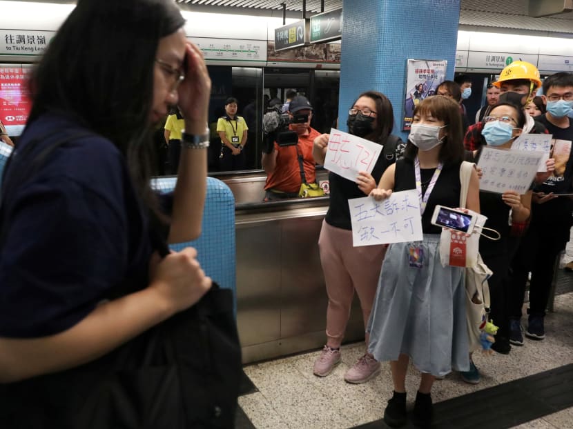Photo of the day: Protesters in Hong Kong call for people to join rallies against the government, while playing a video of alleged police brutality, at Kowloon Tong MTR station on Aug 21, 2019.