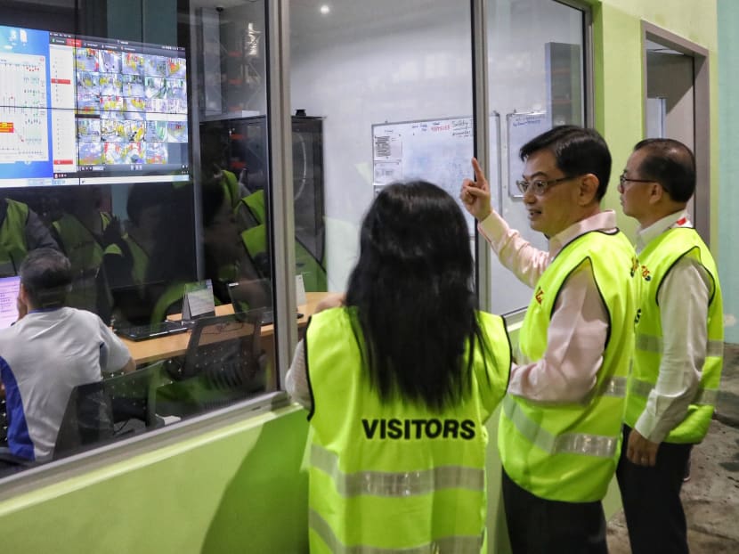 Finance Minister Heng Swee Keat (second from right) visited supermarket NTUC FairPrice’s Benoi Distribution Centre to look at various forms of automation technology that have been implemented and how they improve productivity.