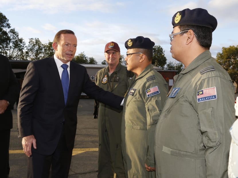 Australian Prime Minister Tony Abbott meets members of Malaysia's Air Force who are currently based at RAAF Base Pearce near Perth March 31, 2014. Photo: Reuters