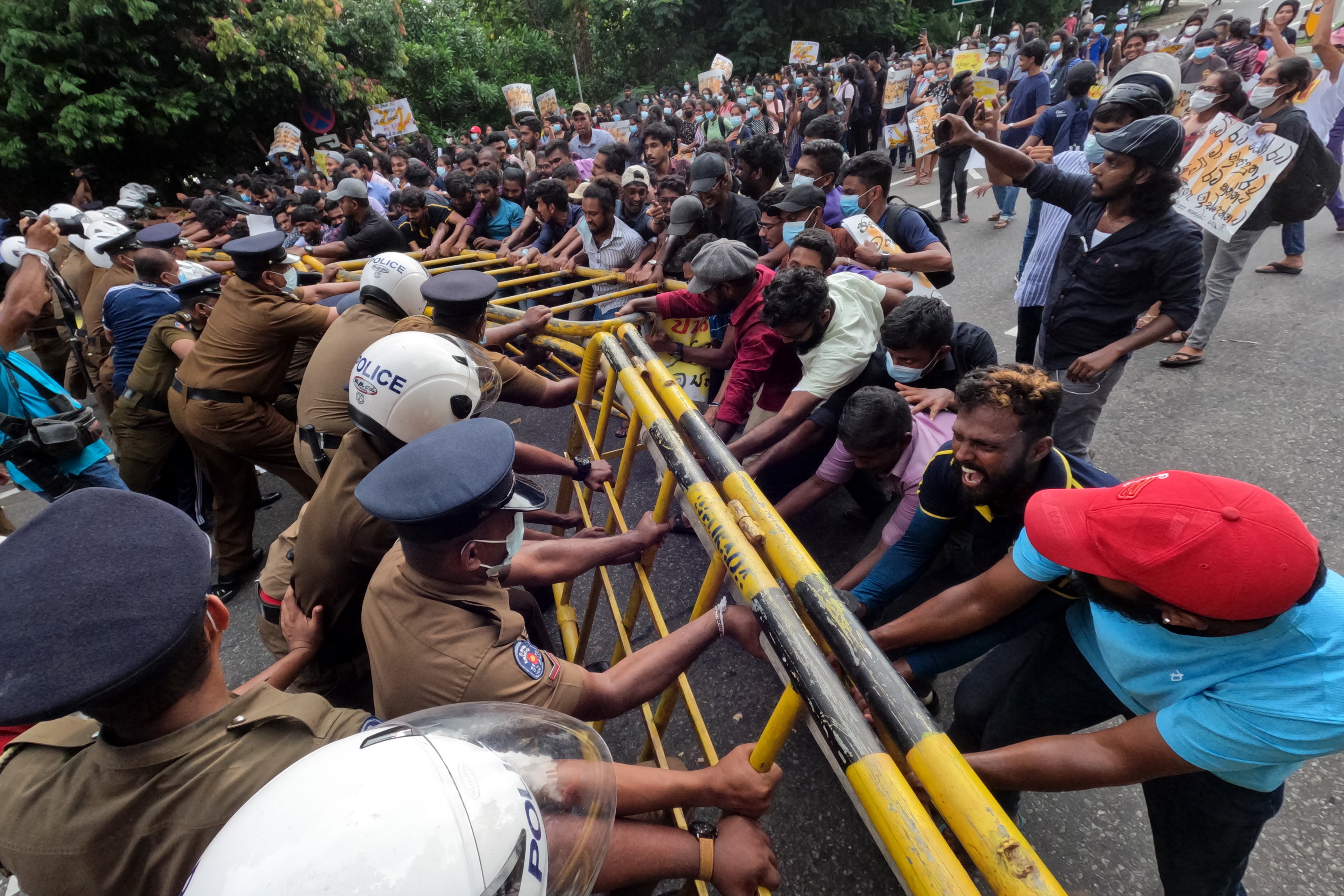 Protesting Sri Lankan university students, demanding the resignation of president Gotabaya Rajapaksa, clash with police officers near parliament in Sri Lanka's capital Colombo on May 4, 2022. 