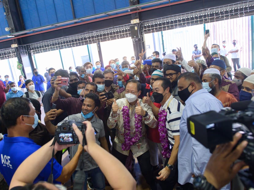 Migrant workers taking a welfie with Manpower Minister Tan See Leng (with thumbs up) and Senior Minister of State for Manpower Koh Poh Koon (to Dr Tan's left) at the Hari Raya celebration at Tuas South Recreation Centre on May 3, 2022.