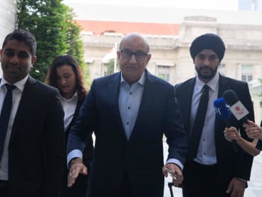 Former Transport Minister S Iswaran (second from right) arriving at the State Courts on March 25, 2024.