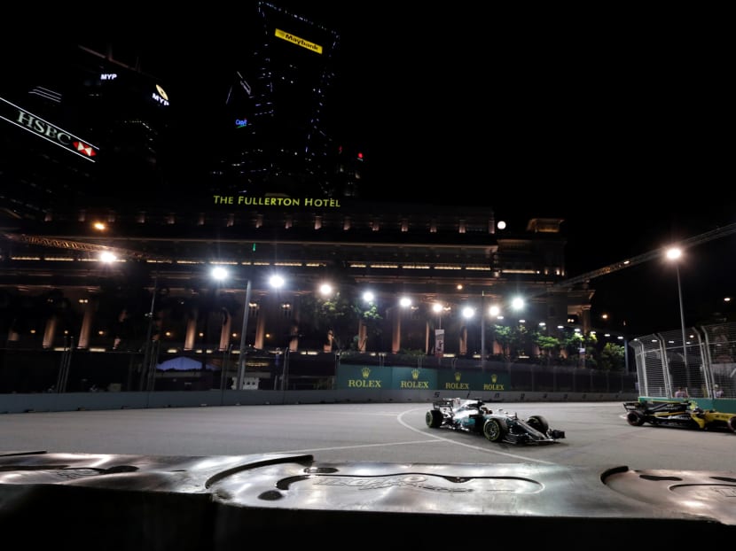 Mercedes' Lewis Hamilton passes Renault's Jolyon Palmer during practice at the Singapore GP. Photo: Reuters