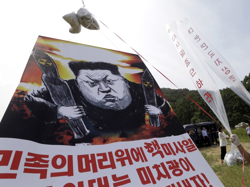In this Sept 15, 2016 file photo, North Korean defectors prepare to release balloons carrying leaflets and a banner denouncing North Korean leader Kim Jong Un for North Korea's latest nuclear test, in Paju, near the border with North Korea, South Korea. The letters read "Let's punish Kim Jong-un and stop nuclear test. " Photo: AP