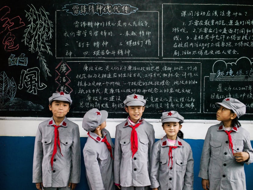 Students posing in front of a blackboard at the Yang Dezhi "Red Army" elementary school in Wenshui, Xishui country in Guizhou province. For decades, the Chinese Communist Party has pushed a stiff regimen of ideological education on students. Now, amid fears that the party is losing its grip on young minds, President Xi Jinping is reshaping political education across China’s more than 283,000 primary and secondary schools for a new era.  Photo: AFP