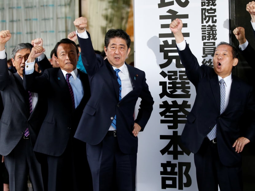 Japan’s Prime Minister Shinzo Abe and his party’s lawmakers making a pledge to win in the upcoming Lower House election, in Tokyo on Sept 28, 2017. Photo: Reuters