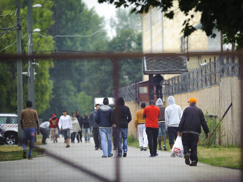 Migrants walk near a reception centre for migrants in Debrecen, Hungary, 230 kms from Budapest, Thursday, June 25, 2015. Photo: AP