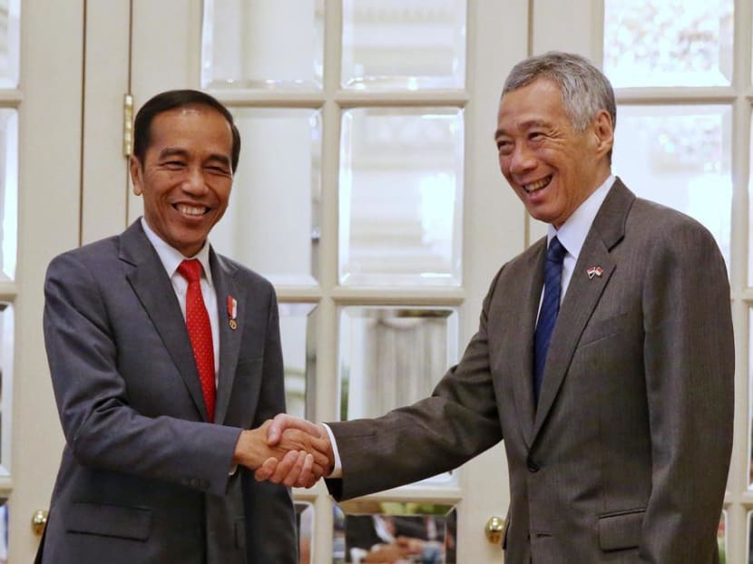 Indonesian President Joko "Jokowi" Widodo (left) with Prime Minister Lee Hsien Loong at the Istana on Oct 8, 2019, as the pair hold their fourth Leaders' Retreat in Singapore.