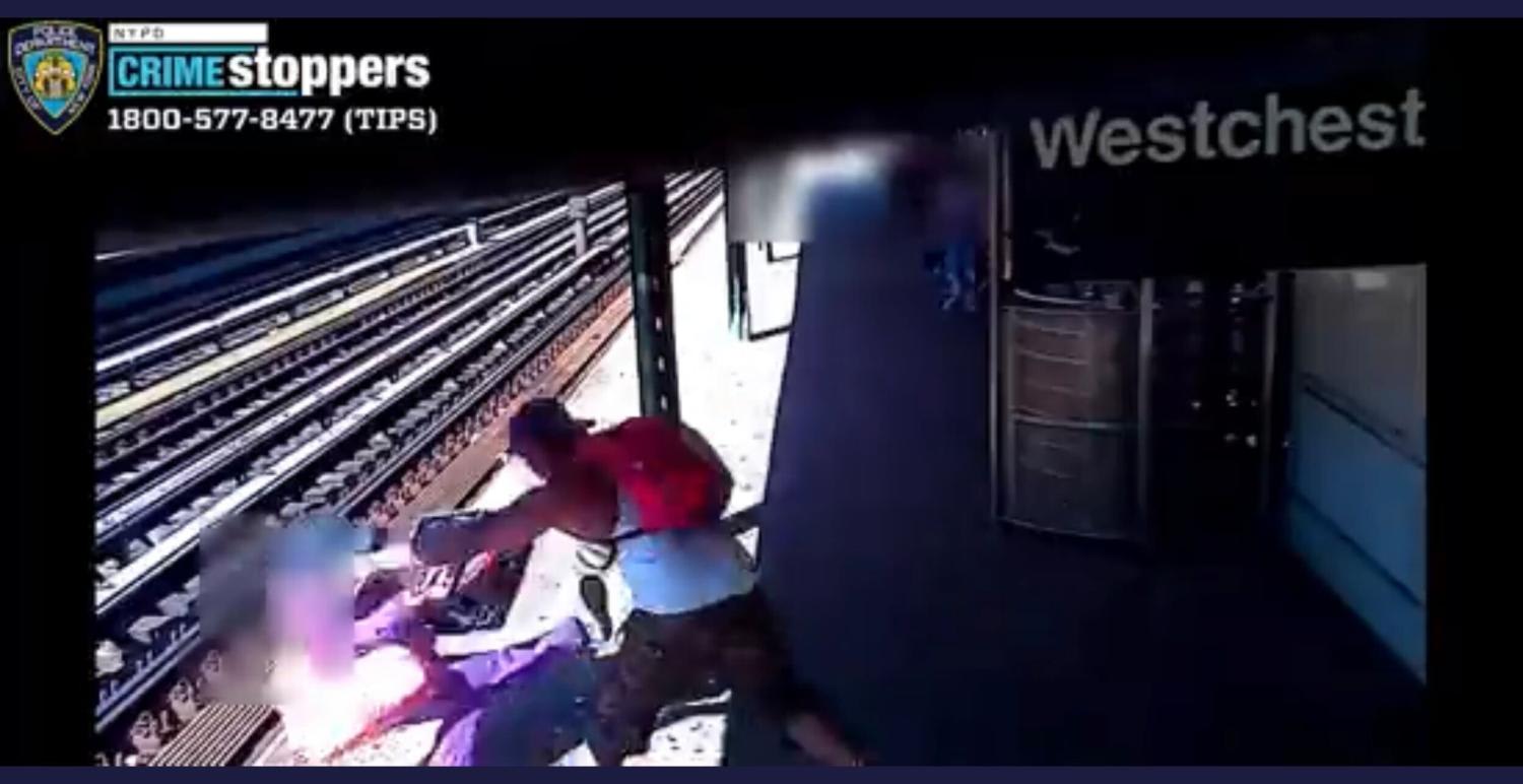 Screengrab from a video shared by the New York Police Department showing a man pushing a woman onto the tracks at a Bronx subway station.