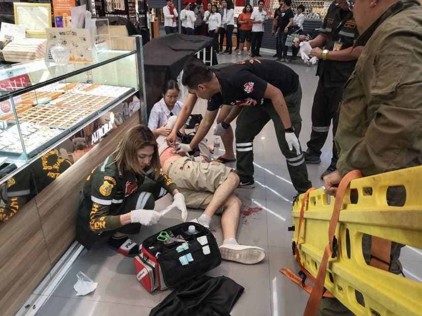 Paramedics helping a man wounded during a robbery at the Robinson shopping mall in the town of Lopburi, some 144km north of Bangkok.
