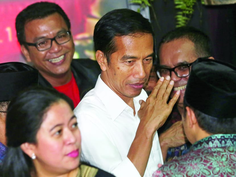President elect in Joko Widodo, centre, gestures after press conference in Jakarta, Indonesia, Tuesday, July 22, 2014. Photo: AP