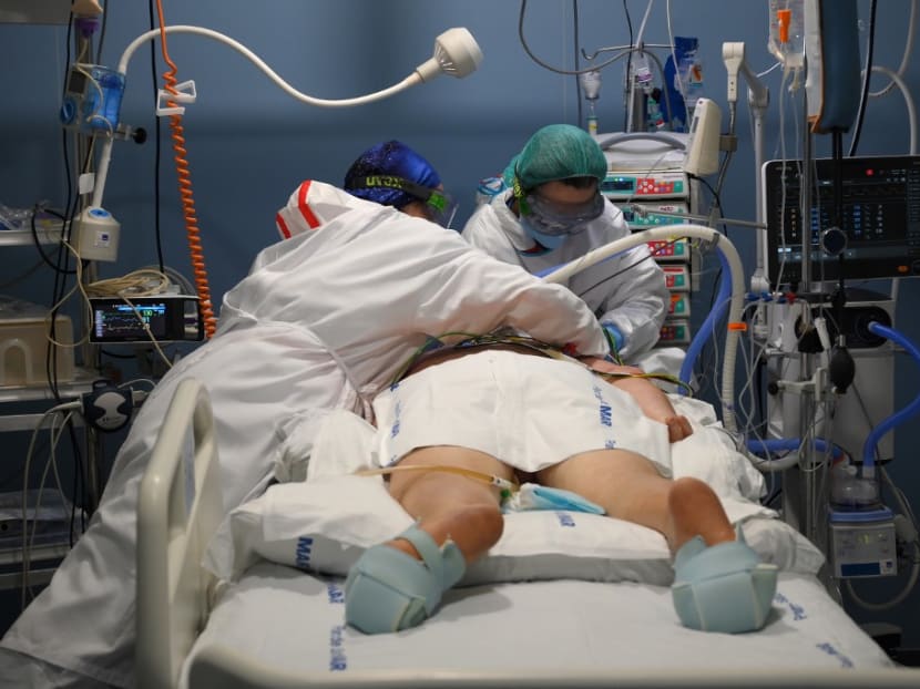 Healthcare workers attend to a patient at the Covid-19 Intensive Care Unit (ICU) of the Hospital Del Mar in Barcelona on Jan 20, 2021. Healthcare workers attend to a patient at the Covid-19 Intensive Care Unit (ICU) of the Hospital Del Mar in Barcelona on Jan 20, 2021.