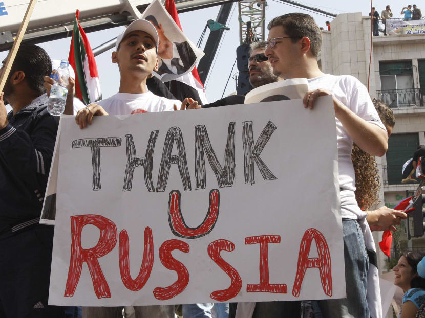 In this Oct 12, 2011 file photo, supporters of the Syrian government hold a pro-Russian banner as they show their support for Syrian President Bashar Assad and to thank Russia and China for blocking a UN Security Council resolution condemning Syria for its brutal crackdown, during a demonstration in Damascus, Syria. Photo: AP