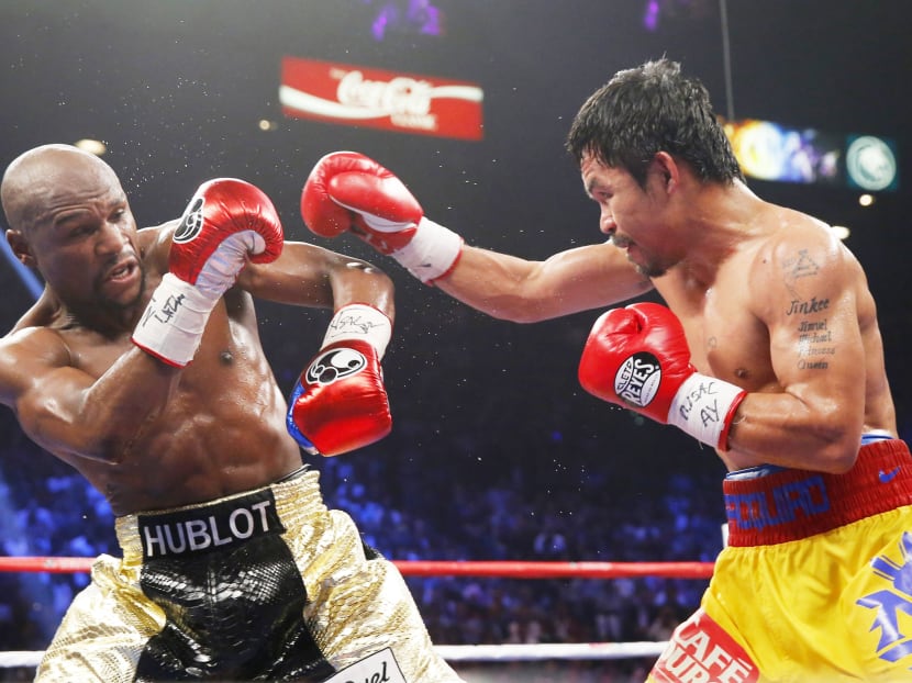 Manny Pacquiao of the Philippines (R) and Floyd Mayweather, Jr of the US fight in the seventh round during their welterweight WBO, WBC and WBA (Super) title fight in Las Vegas, Nevada, May 2, 2015.  Photo: Reuters