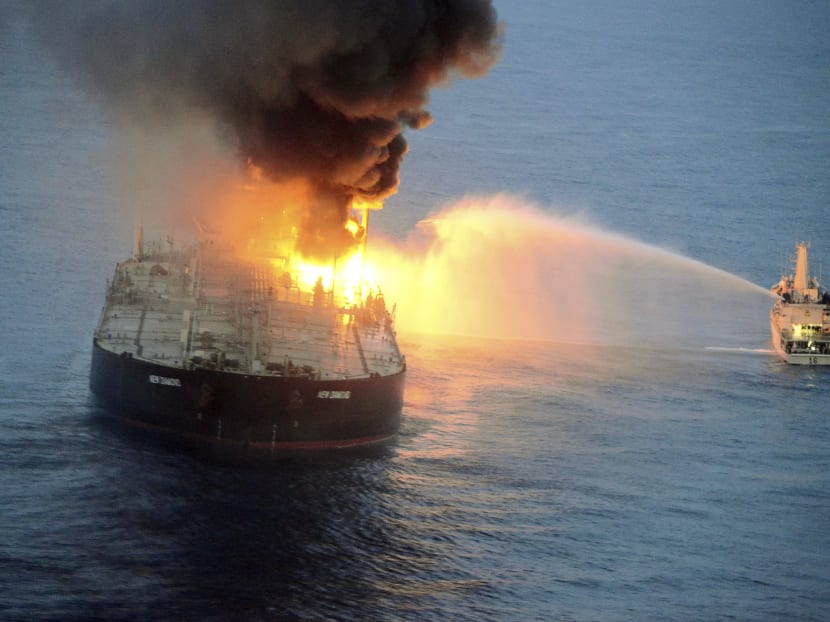 This handout photograph taken on Sept 4, 2020, and released by Sri Lanka's Air Force, shows an Indian coast guard ship battling to extinguish the fire from the Panamanian-registered crude oil tanker New Diamond, some 60 km off Sri Lanka's eastern coast. This handout photograph taken on Sept 4, 2020, and released by Sri Lanka's Air Force, shows an Indian coast guard ship battling to extinguish the fire from the Panamanian-registered crude oil tanker New Diamond, some 60 km off Sri Lanka's eastern coast.