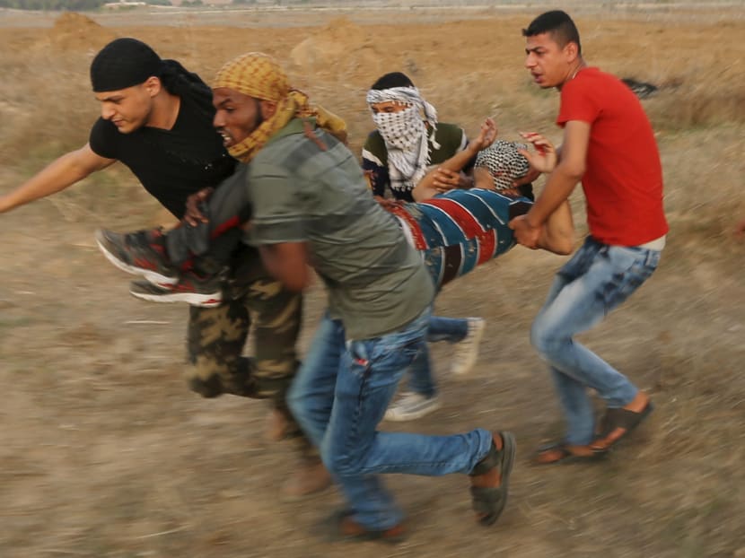 A wounded Palestinian protester is evacuated during clashes with Israeli troops near the border between Israel and Central Gaza Strip Oct 18, 2015. Reuters file photo