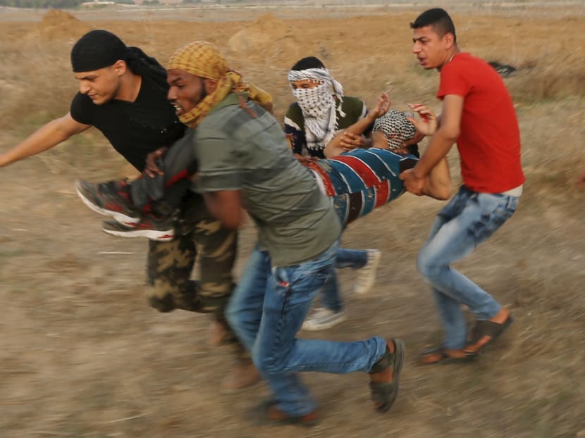A wounded Palestinian protester is evacuated during clashes with Israeli troops near the border between Israel and Central Gaza Strip Oct 18, 2015. Reuters file photo A wounded Palestinian protester is evacuated during clashes with Israeli troops near the border between Israel and Central Gaza Strip Oct 18, 2015. Reuters file photo