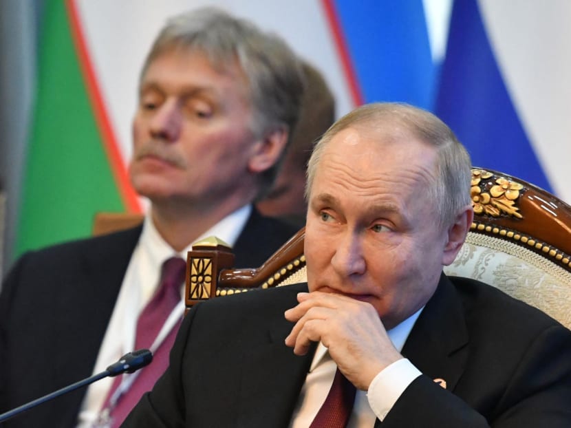 Russia's president Vladimir Putin (right) and his spokesman Dmitry Peskov (left) attend the Supreme Eurasian Economic Council meeting at the Congress Hall in Bishkek on Dec 9, 2022.
