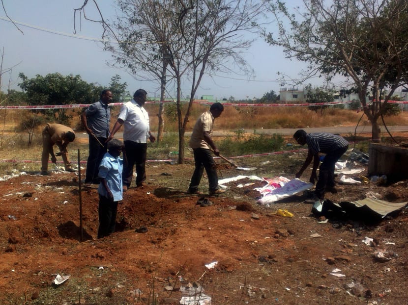 Indian authorities inspect the site of a suspected meteorite landing on February 7, 2016 in Vellore district in southern Tamil Nadu state in an impact that killed a bus driver and injured three others on February 6. Photo: AFP