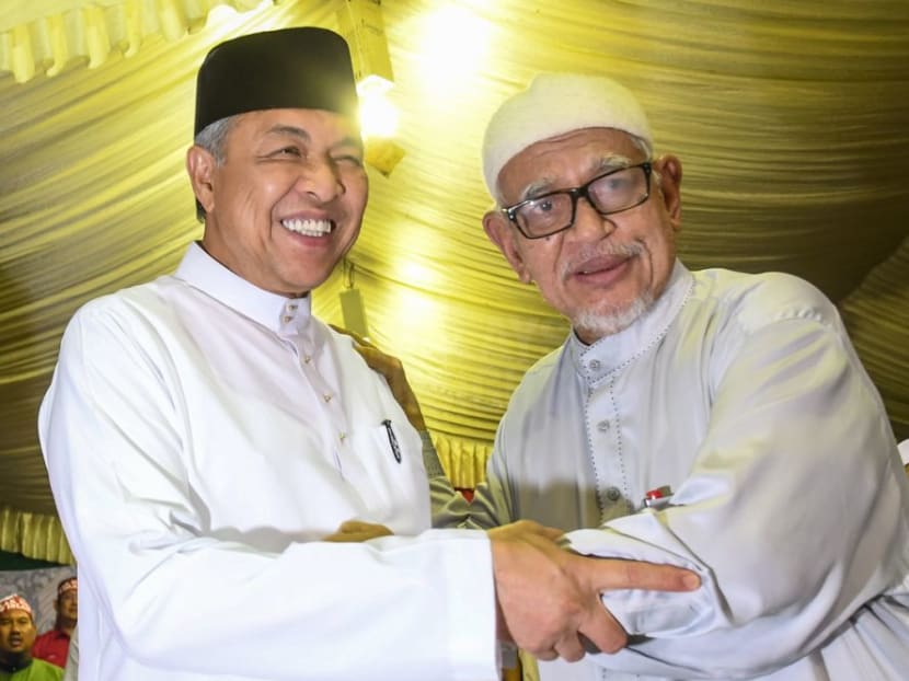 Umno president Ahmad Zahid Hamidi (left) and PAS president Abdul Hadi Awang at a unity gathering in Pasir Salak last month. Umno under Zahid's leadership is moving closer to the Islamist party.