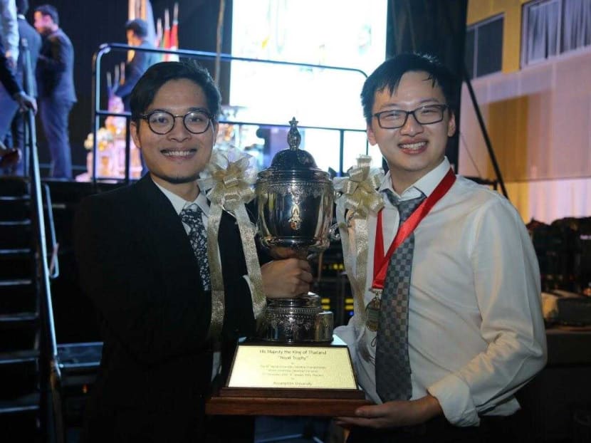 Singaporean Mr Lee Chin Wee (left) and his teammate, Mr Jason Xiao of Canada, holding the King’s Cup which is awarded to the Champions of the 2020 World Universities Debating Championships.