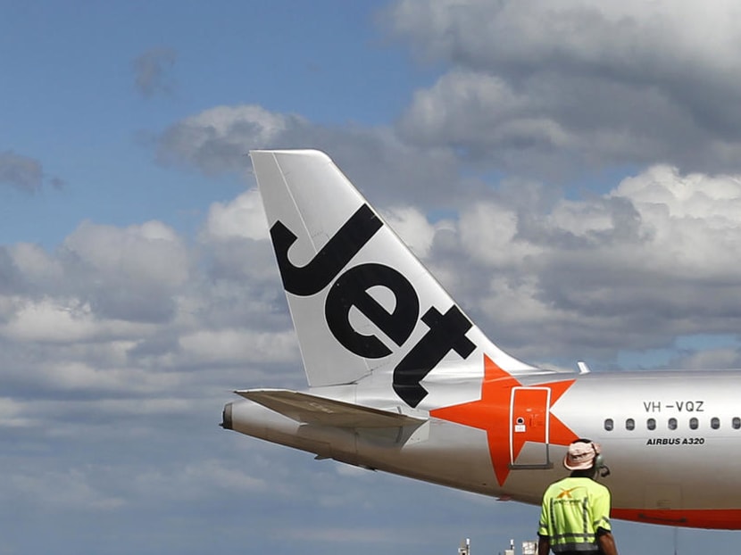 A file photo of an airport worker in front of a Jetstar plane in Melbourne.