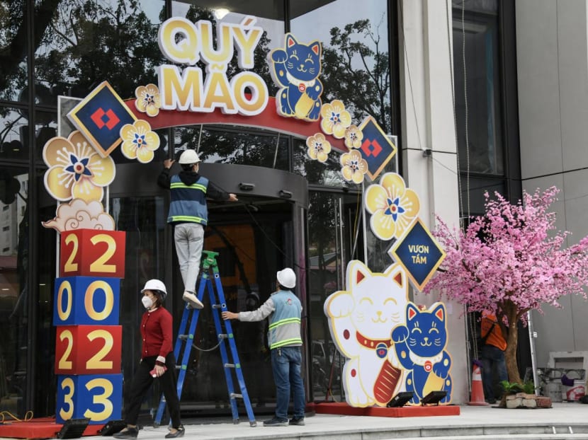 Workers decorate cat figures at a building entrance in Hanoi, ahead of the Lunar New Year, on Jan 16, 2023.