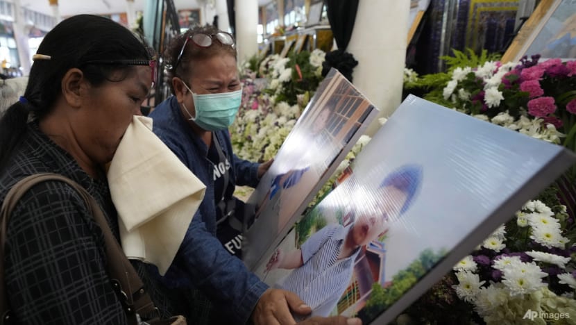Grieving families pray at Thai temple for slain nursery victims