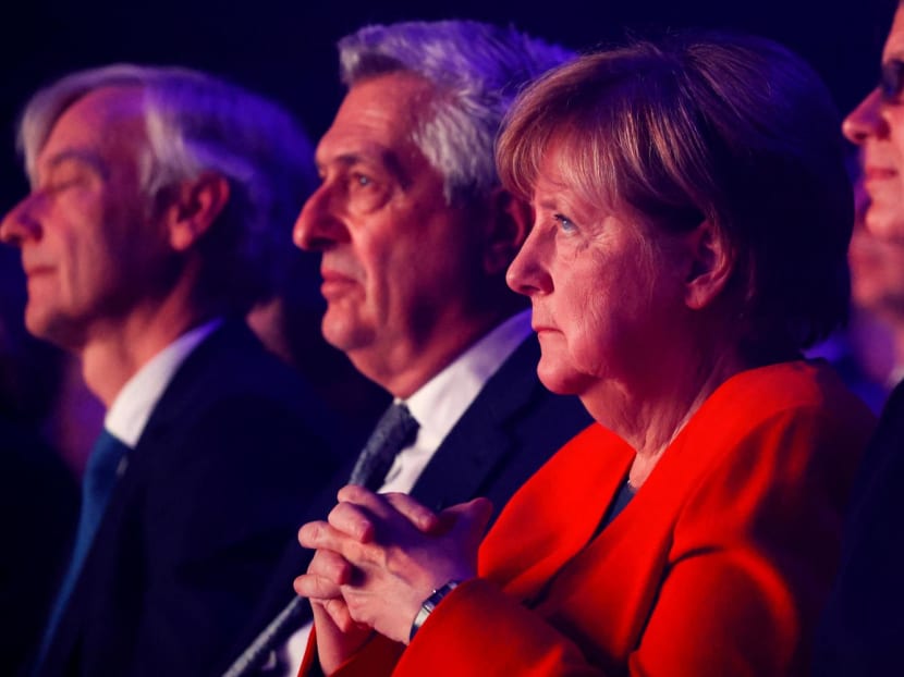 Germany's former chancellor Angela Merkel (2nd-R) and United Nations High Commissioner for Refugees Filippo Grandi (2nd-L) attend the UNHCR Nansen Refugee Award ceremony in Geneva on Oct 10, 2022.