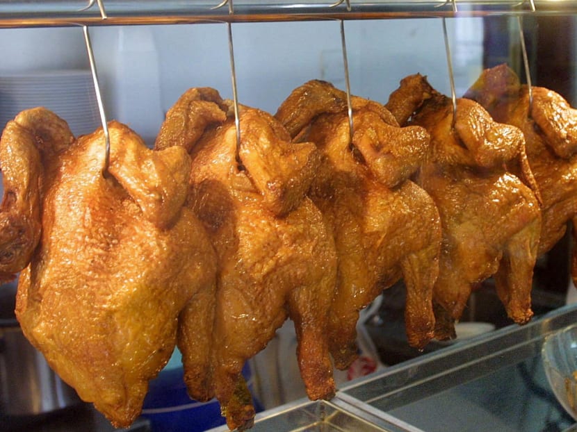 Roast chicken on display at a chicken rice stall.&nbsp;