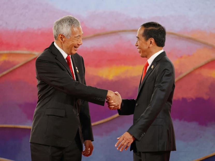 Indonesian President Joko Widodo (right) greets Singapore's Prime Minister Lee Hsien Loong at the Asean Summit held in Labuan Bajo, Indonesia, on May 10, 2023.