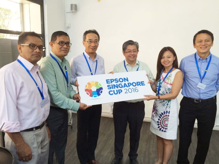 FAS president Zainudin Nordin (left) poses with staff yesterday from Sinad Sports Group and Epson at the unveiling of the Epson Singapore Cup, to be held at Safra Tampines Sept 3-10. Photo: Epson Singapore