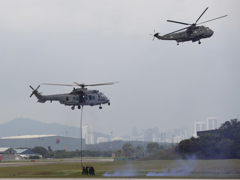 Malaysian special forces demonstrate their skills in fighting terrorists from helicopters after Malaysia, Indonesia and The Philippines launch air patrols to intensify their fight against Islamic militants. Photo: AP