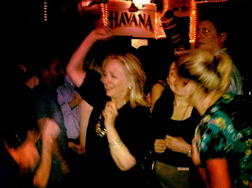 In this file photo taken on April 15, 2012, US Secretary of State Hillary Clinton enjoys a relaxing moment at Cafe Havana in Cartagena, Colombia. In this file photo taken on April 15, 2012, US Secretary of State Hillary Clinton enjoys a relaxing moment at Cafe Havana in Cartagena, Colombia.