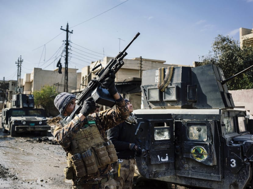 An Iraqi special forces Counter Terrorism Service (CTS) member shoots at a drone flown by Islamic State group jihadists (IS) in Mosul's al-Rifaq neighbourhood on Jan 8, 2017, during an ongoing military operation against the militants.
 Photo: AFP