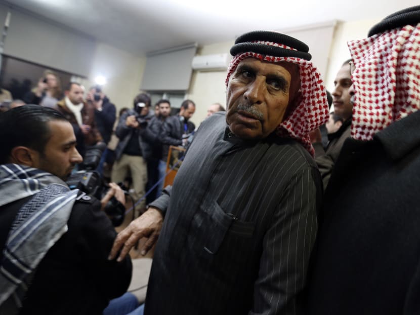 Safi Yousef (C), father of Islamic State captive Jordanian pilot Muath Kasaesbeh, leaves a news conference where he asked Islamic State to pardon and release his son, in Amman yesterday (Jan 29). Photo: Reuters
