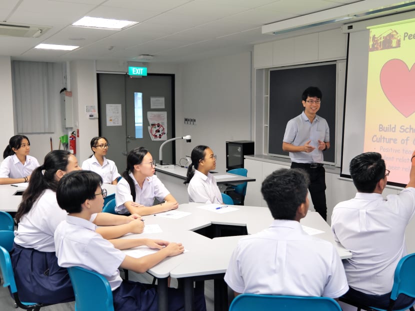 Mr Ow Gan Pin, 45, who is Dunearn Secondary School’s head of department for Character and Citizenship Education (CCE), is seen teaching students the purpose of peer support during a training session with a group of peer support leaders.