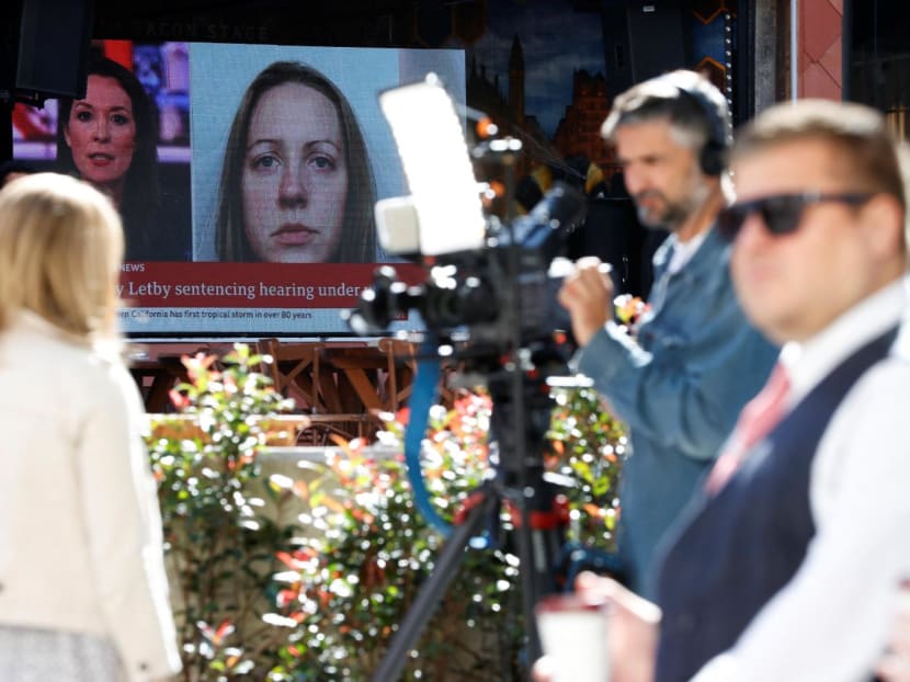 Members of the media work near a large screen showing a picture of convicted hospital nurse Lucy Letby, ahead of her sentencing, outside the Manchester Crown Court, in Manchester, Britain on Aug 21, 2023.