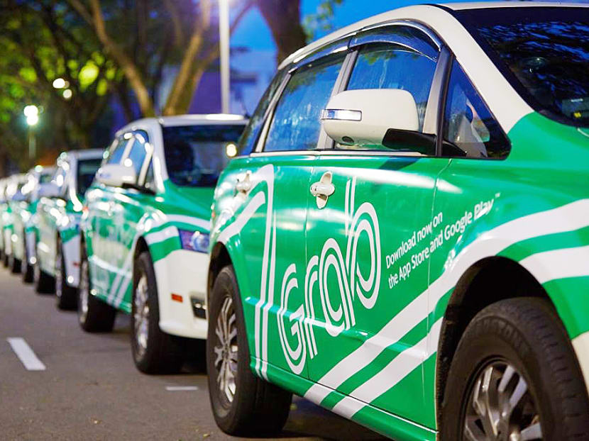 Ride-hailing firm Grab announced a new and exclusive partnership with SMRT to build the largest taxi and private-hire car fleet in Singapore. Photo: Grab