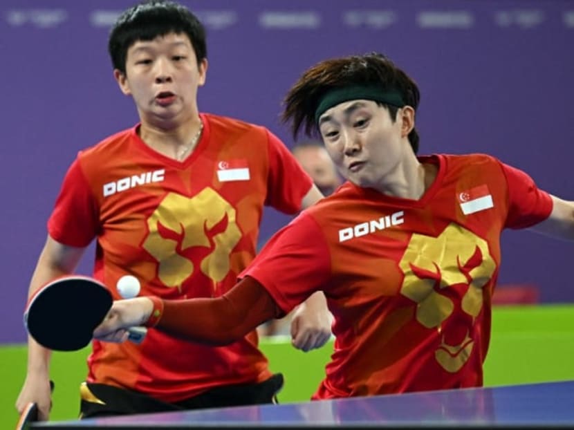 Singapore's Zeng Jian (left) and Feng Tianwei play against Australia in the women's doubles gold medal table tennis match on day 11 of the Commonwealth Games at the NEC arena in Birmingham, England, on Aug 8, 2022.