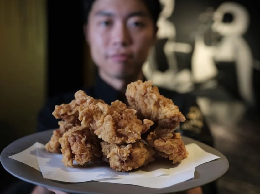 Chef Yong Soo-do with his Korean fried chicken, whose preparation includes marinating it overnight in brine, then putting it in a tempura batter with home-made chicken powder.