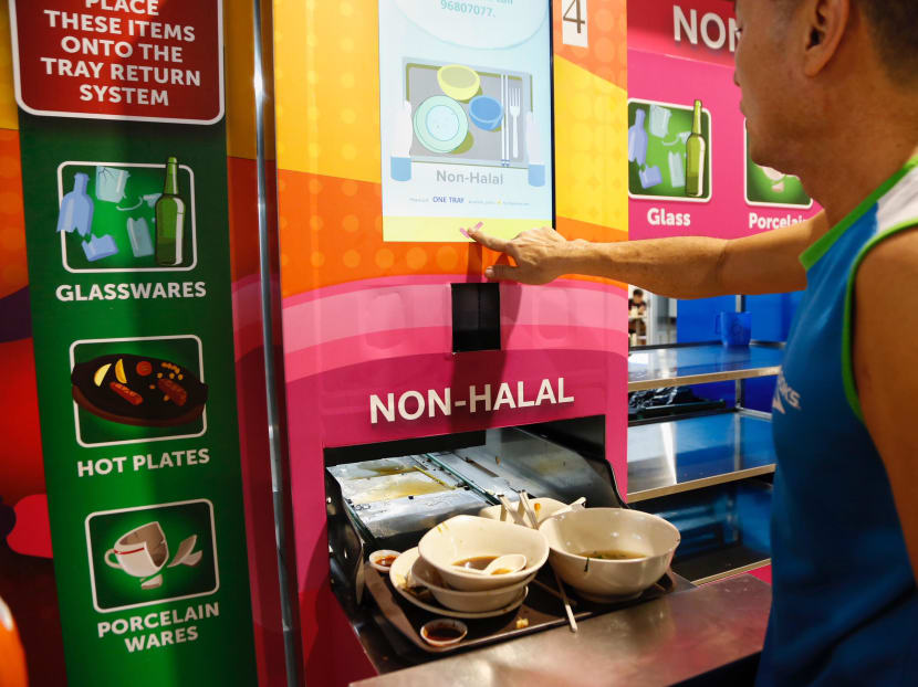 A customer at Marsiling Mall Hawker Centre returning his tray. A 50 cents deposit will be refunded when a tray is returned. Up to 25 existing hawker centres will have an automated tray return system installed. Photo: Raj Nadarajan/TODAY