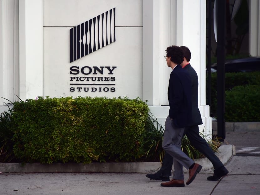 Pedestrians walk past an exterior wall to Sony Pictures Studios in Los Angeles, California on December 4, 2014, a day after Sony Pictures denounced a "brazen" cyber attack by Pyongyang which netted a "large amount" of confidential information. Photo: AFP